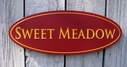 Custom carved wood sign with gold painted lettering